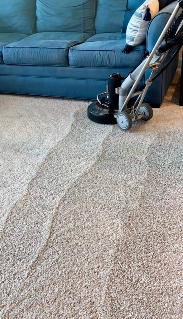 Low-moisture carpet cleaning next to a sofa