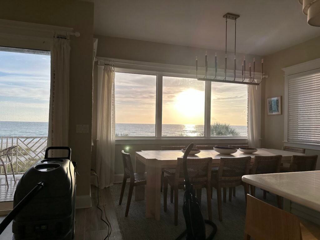 Oh Limpio portable cleaning equipment in a beachfront vacation rental dining room at sunset