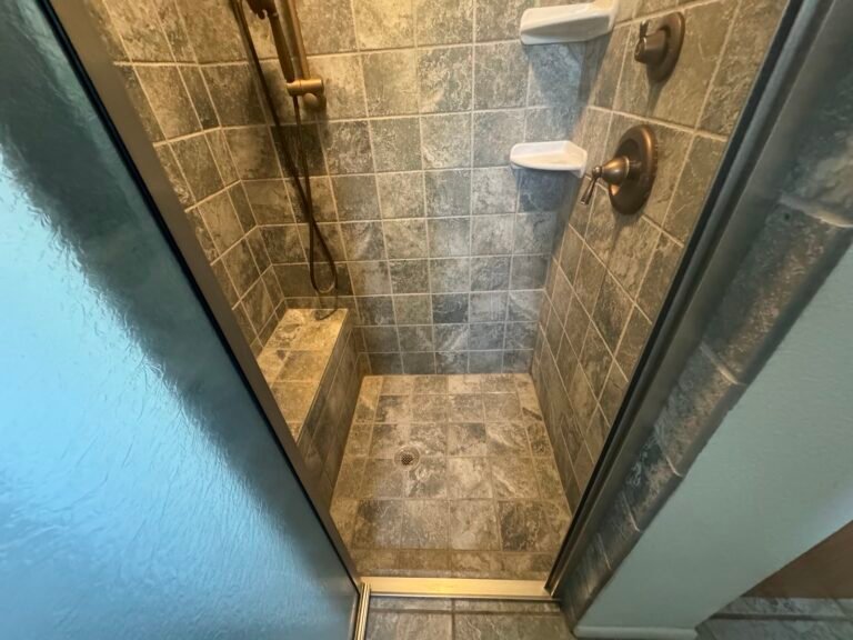 Stone tile walk-in shower after restoration and sealing